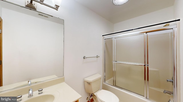 full bathroom featuring shower / bath combination with glass door, vanity, and toilet