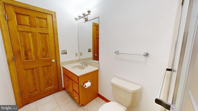 bathroom featuring tile patterned flooring, vanity, and toilet