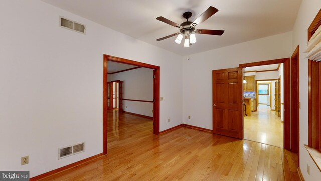 kitchen with hanging light fixtures, sink, light hardwood / wood-style flooring, black appliances, and a center island