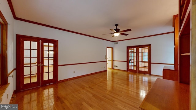 spare room with french doors, light hardwood / wood-style flooring, and ceiling fan