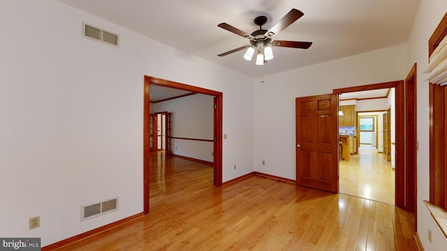 spare room featuring light wood-type flooring and ceiling fan