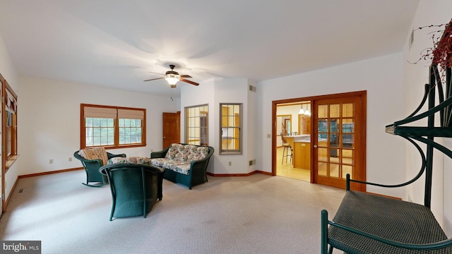 living room featuring ceiling fan, light colored carpet, and french doors