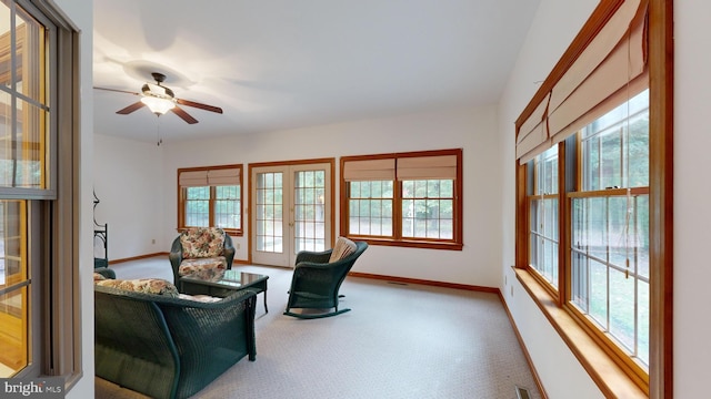 living area with ceiling fan and carpet floors