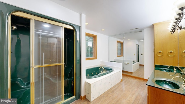 bathroom featuring vanity, shower with separate bathtub, and hardwood / wood-style floors