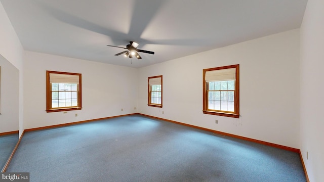 carpeted spare room featuring ceiling fan