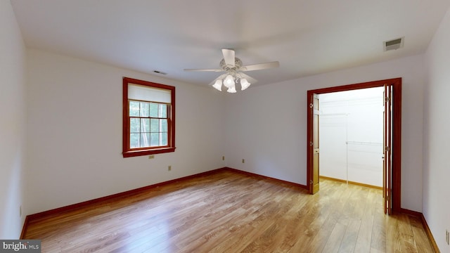 empty room featuring ceiling fan and light hardwood / wood-style flooring