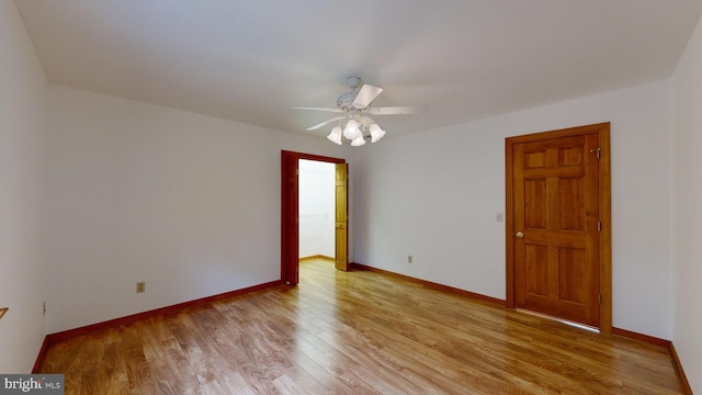 spare room with light hardwood / wood-style flooring and ceiling fan