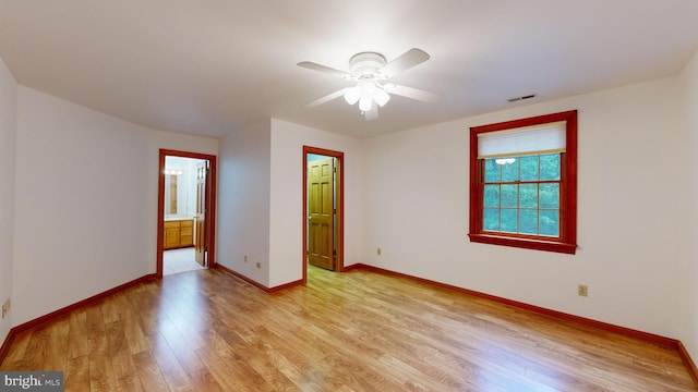 spare room with light wood-type flooring and ceiling fan