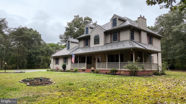 view of front of house featuring covered porch and a front yard