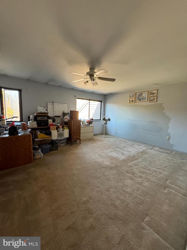 interior space with ceiling fan