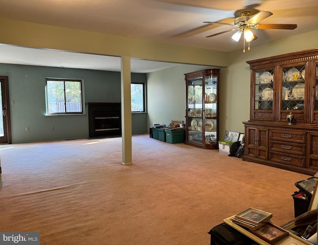 interior space featuring ceiling fan and light colored carpet