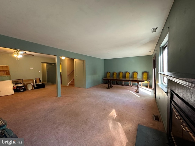 interior space with ceiling fan and carpet floors