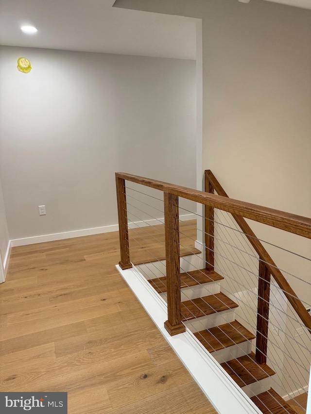 stairs with hardwood / wood-style floors