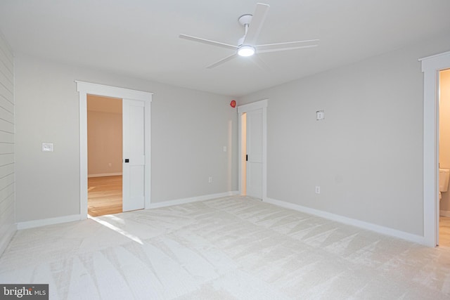 spare room featuring light carpet and ceiling fan