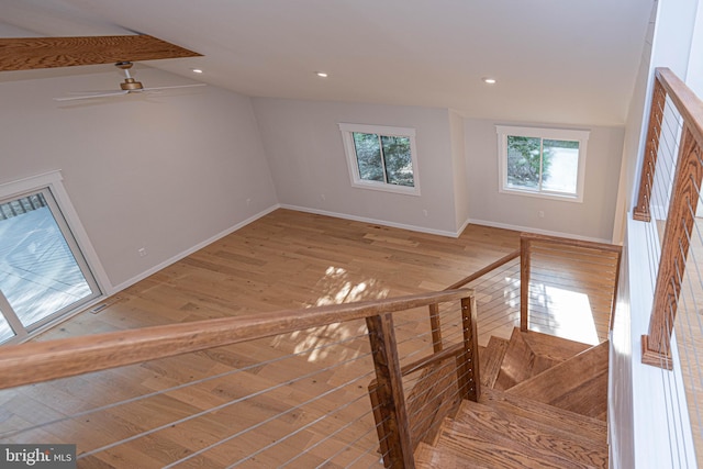 interior space featuring vaulted ceiling, light hardwood / wood-style floors, and ceiling fan