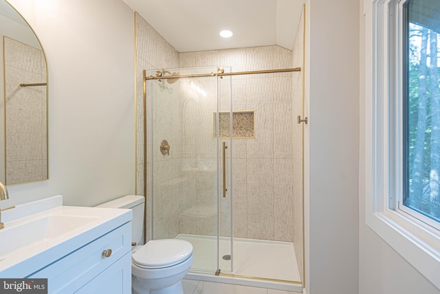 bathroom featuring vanity, toilet, and an enclosed shower