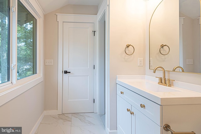 bathroom featuring vanity and lofted ceiling