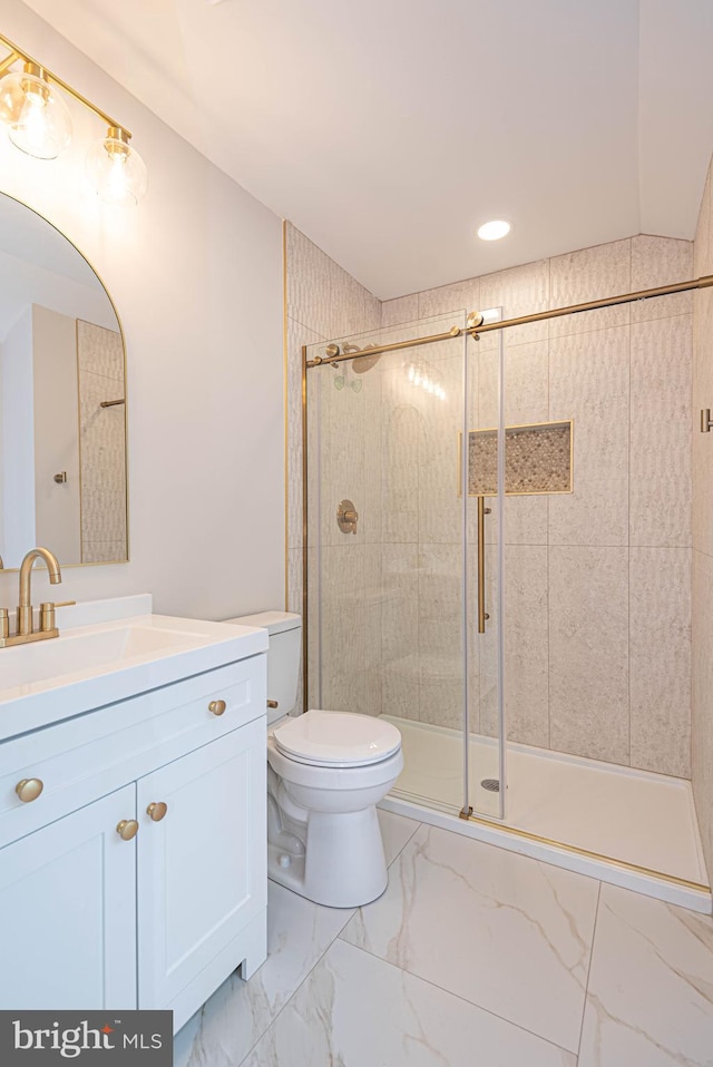 bathroom with vanity, toilet, and walk in shower