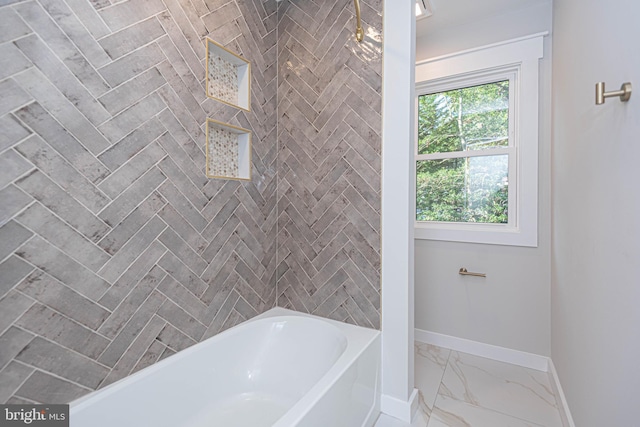 bathroom featuring tiled shower / bath combo