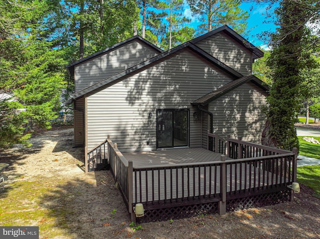 back of property featuring a wooden deck