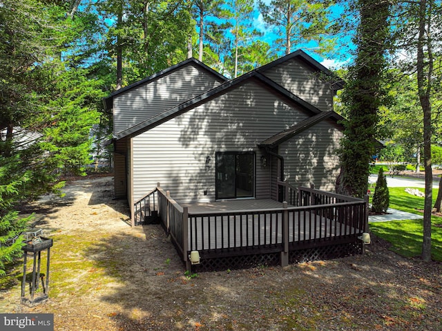 back of house featuring a wooden deck