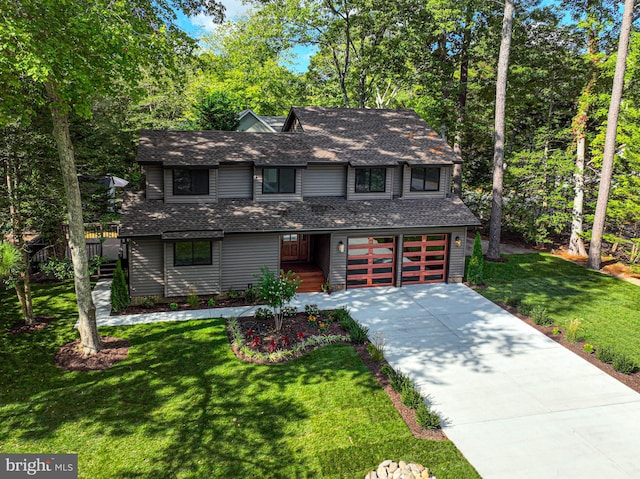 front of property featuring a front yard and a garage