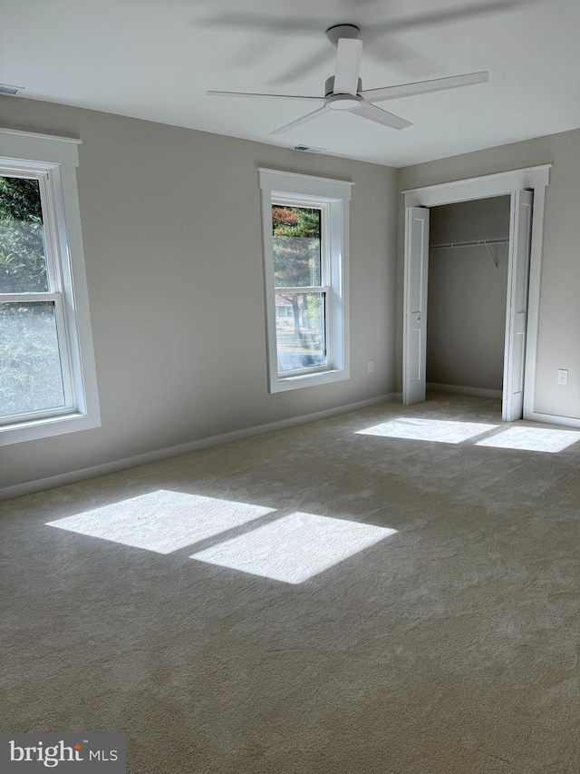 unfurnished bedroom featuring light colored carpet and ceiling fan