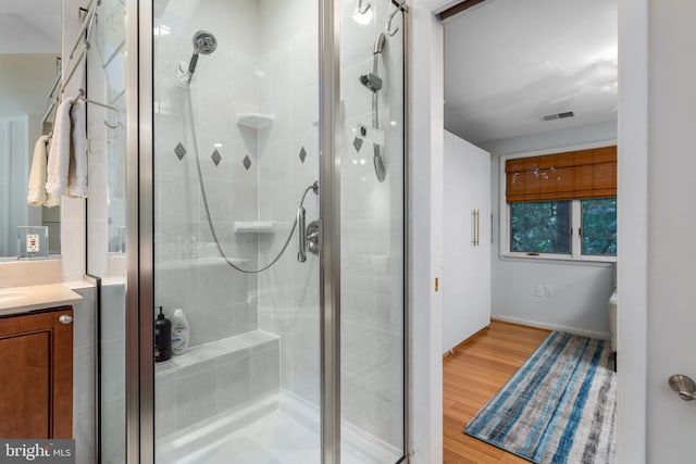 bathroom featuring vanity, hardwood / wood-style floors, and an enclosed shower