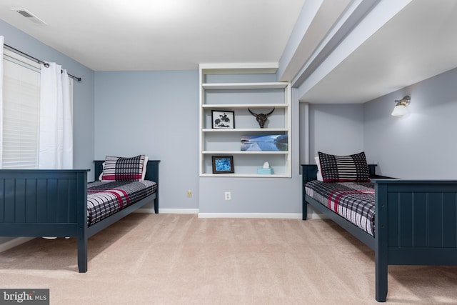 bedroom featuring light colored carpet