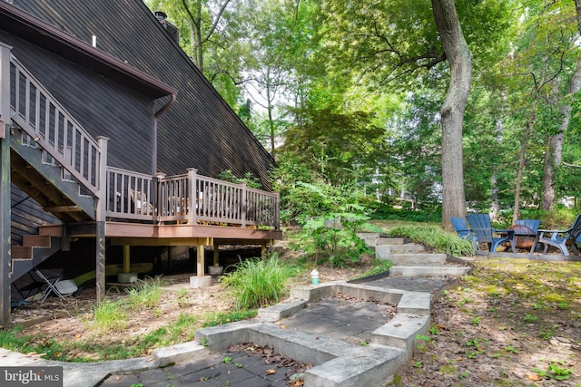 view of yard featuring a fire pit and a deck