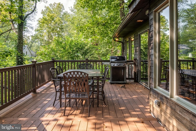 wooden terrace featuring a grill