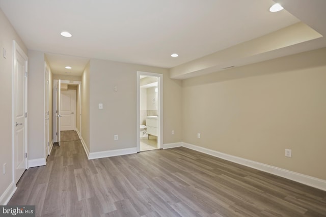 interior space with ensuite bathroom and hardwood / wood-style flooring