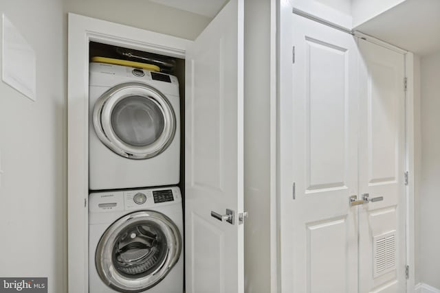 laundry area featuring stacked washer and dryer