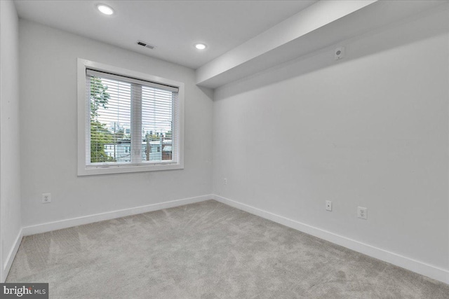 unfurnished room with light colored carpet