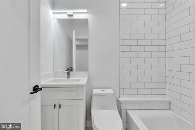 bathroom with vanity, toilet, and a bathing tub