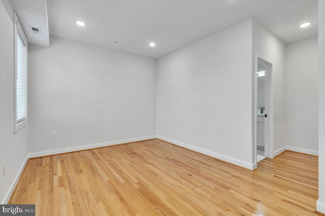 empty room with light hardwood / wood-style floors