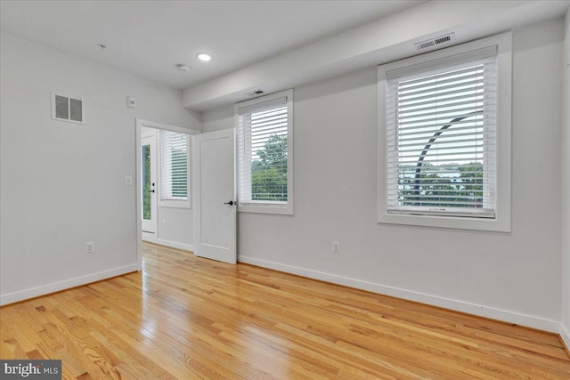 spare room with plenty of natural light and light wood-type flooring