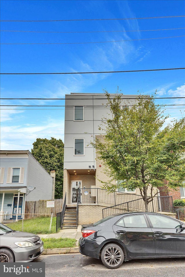 1416 22nd St SE Unit 9, Washington, DC 20020 - view of front of house with stucco siding and fence