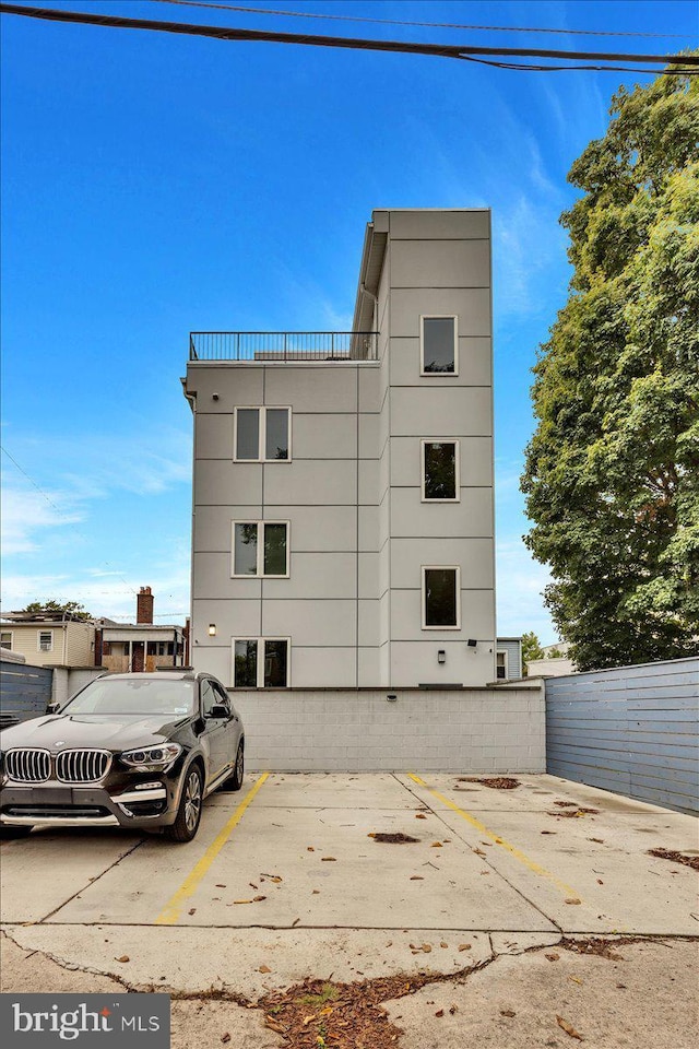 1416 22nd St SE Unit 9, Washington, DC 20020 - view of building exterior featuring fence and uncovered parking