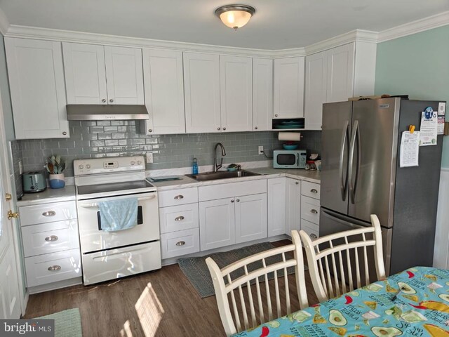 kitchen featuring dark hardwood / wood-style floors, tasteful backsplash, sink, white cabinetry, and white appliances