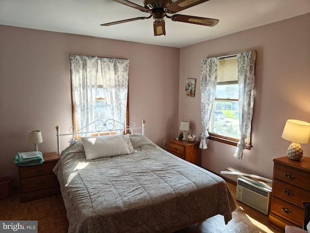 bedroom featuring ceiling fan and dark parquet flooring