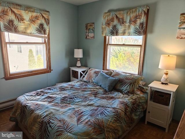 bedroom featuring dark parquet floors and baseboard heating