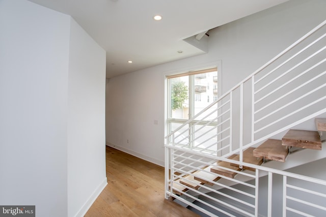 stairs featuring wood-type flooring