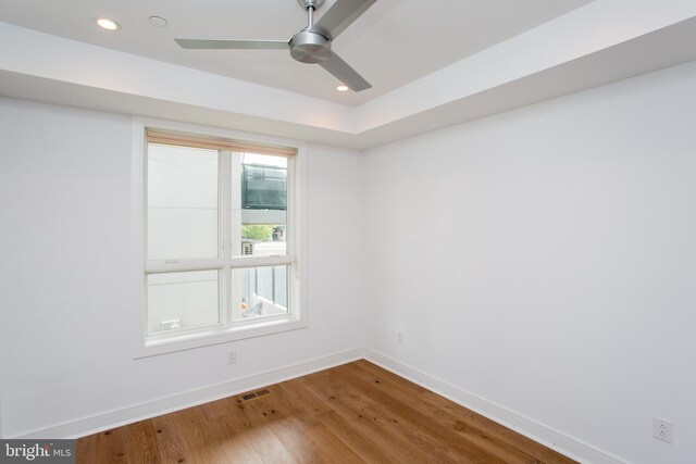 spare room with hardwood / wood-style floors and ceiling fan