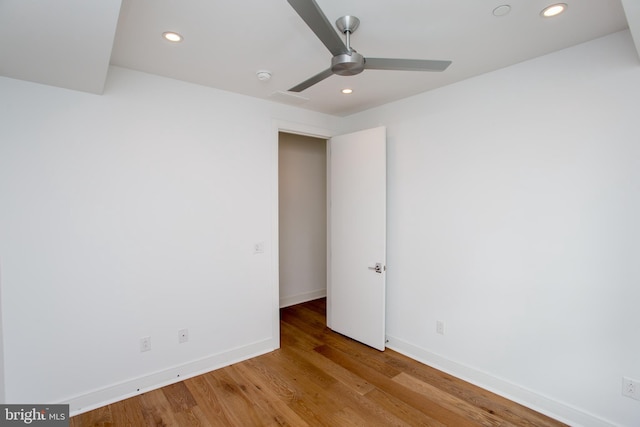 empty room featuring ceiling fan and light hardwood / wood-style flooring