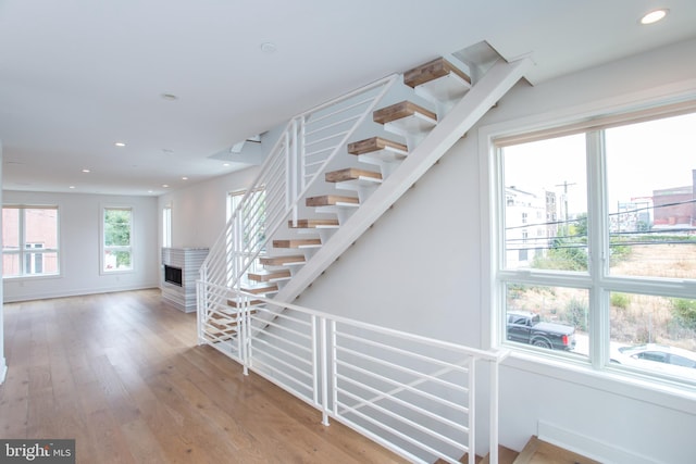 stairway with hardwood / wood-style flooring