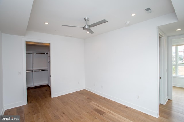 unfurnished bedroom with ceiling fan, a closet, and light hardwood / wood-style flooring