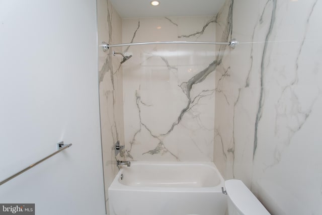 bathroom featuring tiled shower / bath and toilet