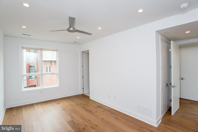 spare room featuring ceiling fan and light hardwood / wood-style flooring