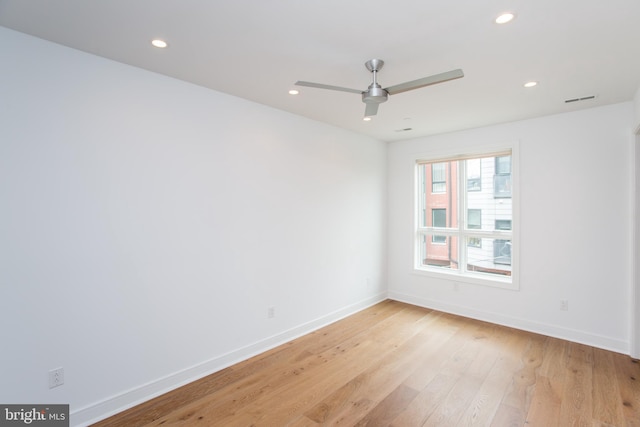 empty room featuring ceiling fan and light hardwood / wood-style floors